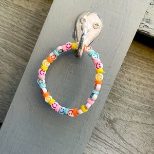 I’m selling a clay bead bracelet with smiley faces fits anyone!